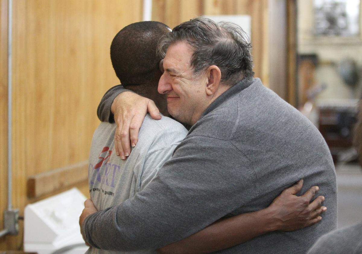 This file photo shows Joe Hubbard embracing an employee at the St. Vincent de Paul store in 2010 in East St. Louis.