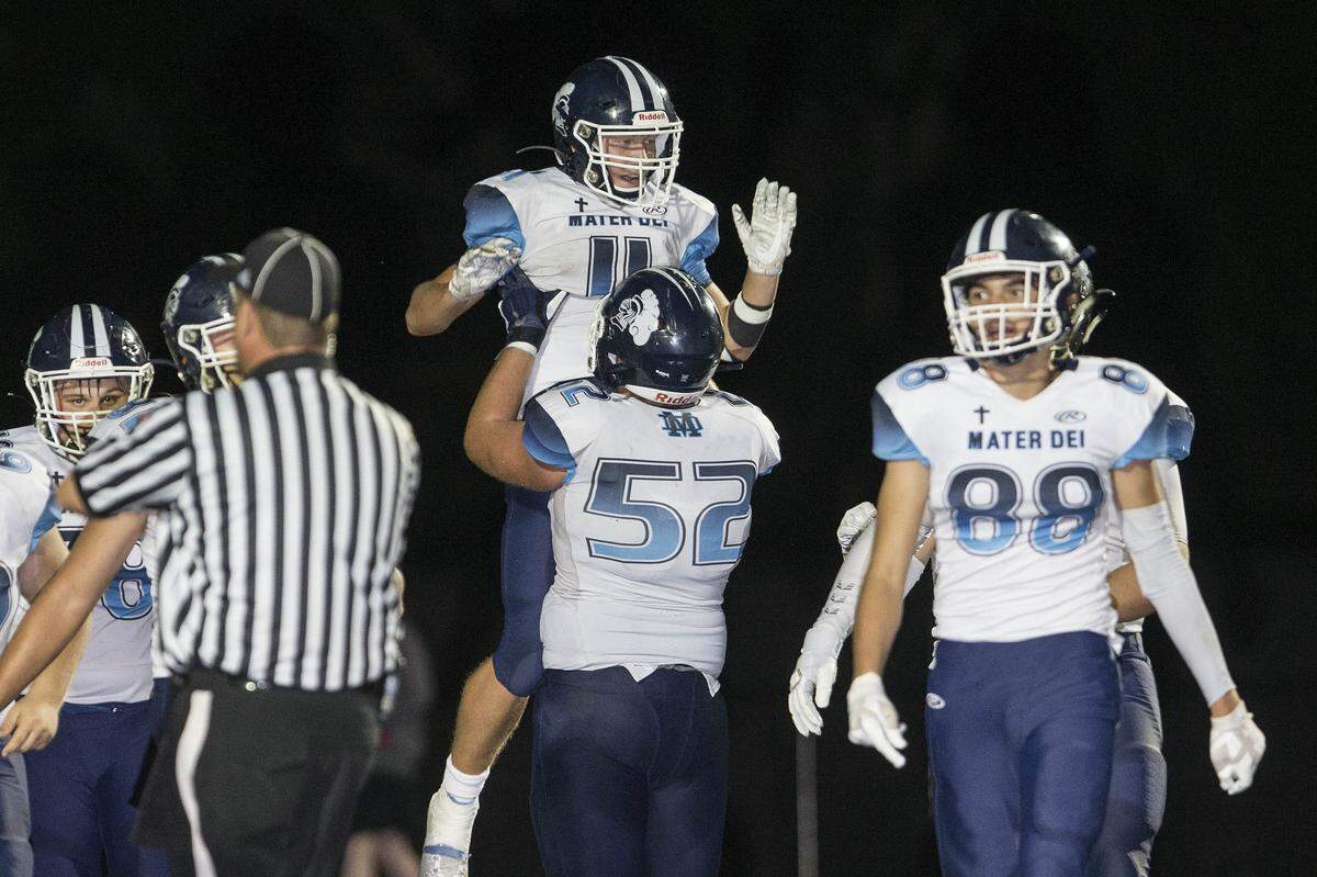 Mater Dei’s Zach Napovanice celebrates with teammates after one of his touchdown receptions in the first half of the Knights 41-20 win against Althoff on Sept. 13. Napovanice rushed for 210 yards and four touchdowns on 30 carries Friday, helping Mater Dei rally past Freeburg 25-14.