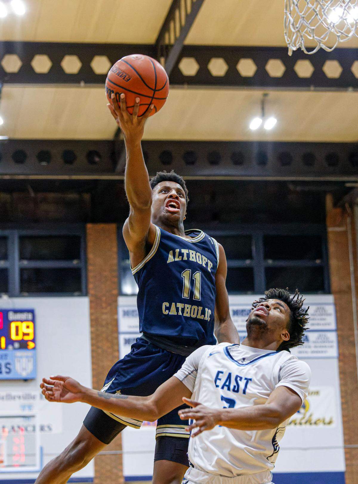 Althoff’s Taylor Powell shoots over Belleville East’s Tallis Lowery during Tuesday’s non-conference game. The Crusaders ultimately dropped a 78-50 decision to the Lancers.