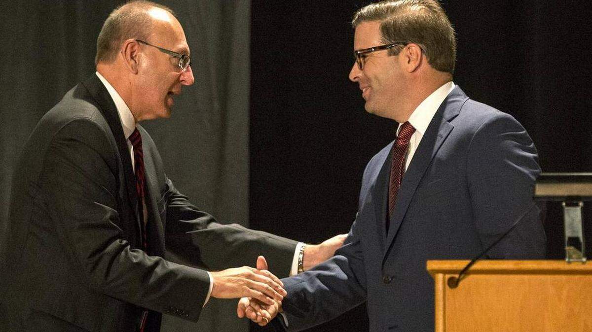 Michael Shonrock, left, was fired as president of the Lindenwood University System based in St. Charles, Mo., on Friday. In this photo from 2015,  he is shaking hands with Brett Barger, who was the president of Lindenwood University-Belleville until Jan. 22 when Shonrock said Barger had left the university. Barger had been placed on administrative leave last fall.