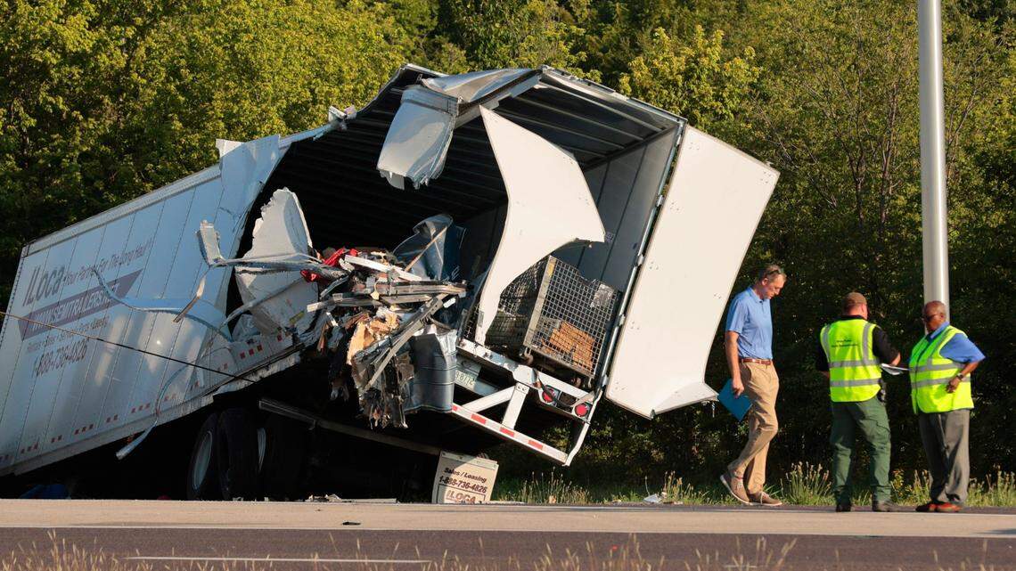 Officials survey a damaged tractor-trailer before removing it from the scene on Wednesday, July 12, 2023, on westbound Interstate 70 after it collided with a Greyhound bus near Highland, Ill. (Christian Gooden/St. Louis Post-Dispatch via AP)