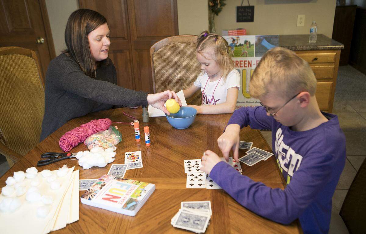 Collinsville resident Shannon Philpott-Sanders is the author of "Screen-Free Fun: 400 Activities for the Whole Family."  Here, she demonstrates some of the activities with her niece, Persephone Jaenke, 6, and nephew, Aiden Freeland, 10.