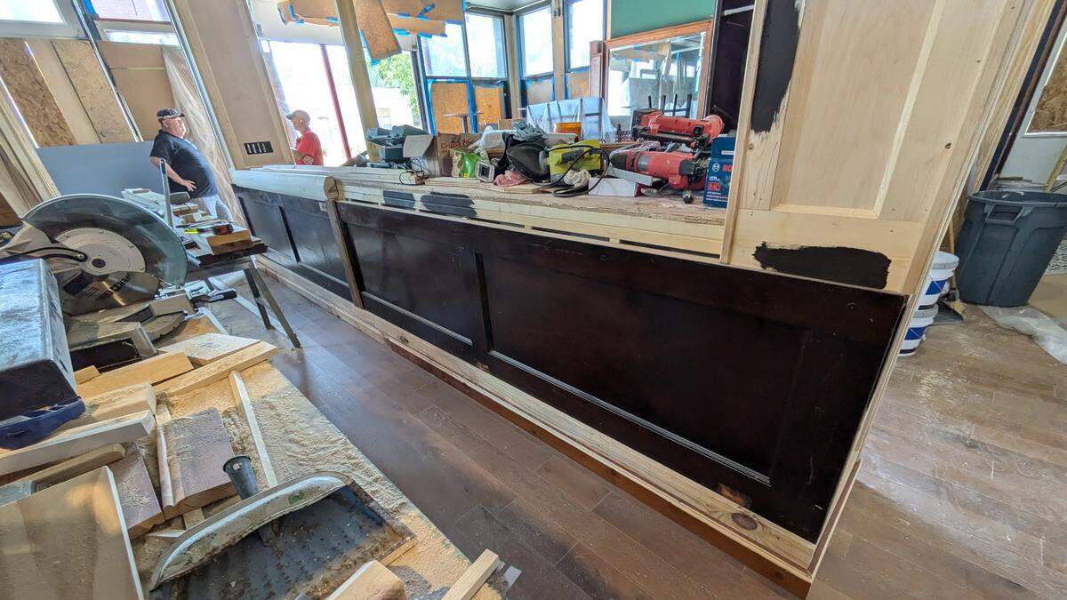 The new middle bar at The Harp Pub includes repurposed mahogany panels found at a Missouri church.