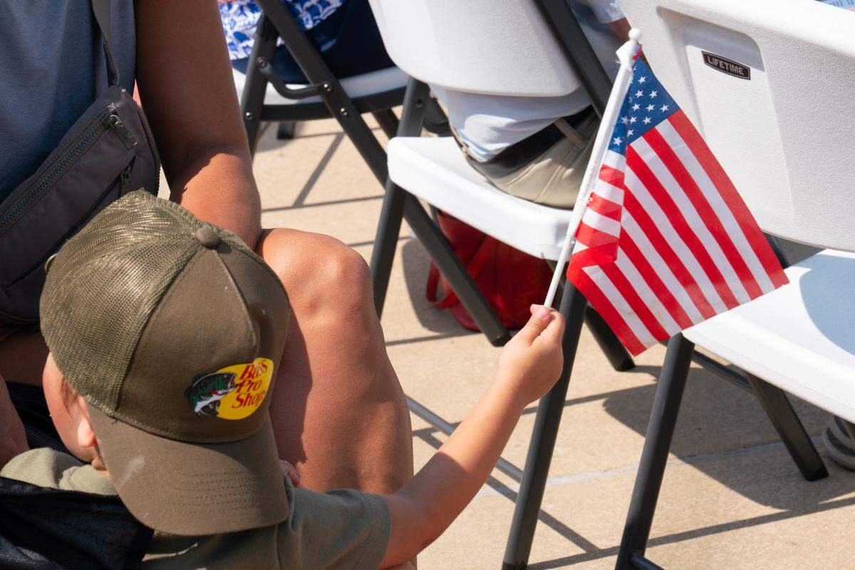 A child shows his support during a 9/11 remembrance ceremony along the 9/11 Memorial Walkway at Belleville firehouse #4.