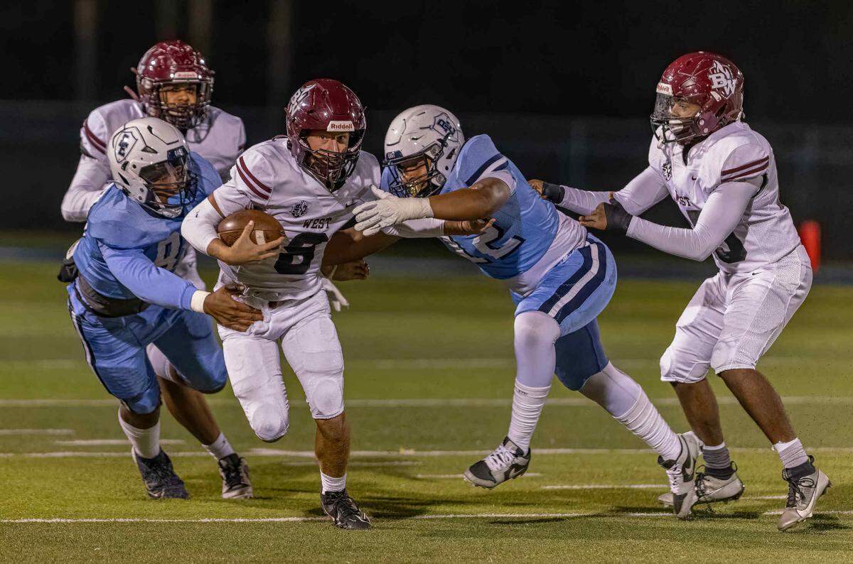 October 18, 2024 - Belleville IL, Belleville West Caiden Capell (8) carries the ball while under pressure during FridayÕs Southwestern Conference matchup between Belleville East and Belleville West [Photo: Jimmy Simmons]