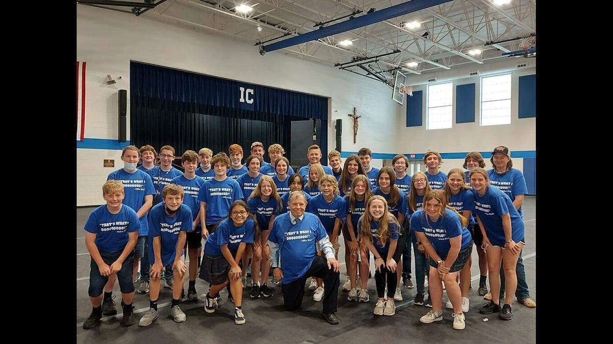 Principal Michael Kish poses with eighth-graders at Immaculate Conception Catholic School in Columbia earlier this week. They’re wearing T-shirts with one of his common sayings, “That’s what I doooooooo!”