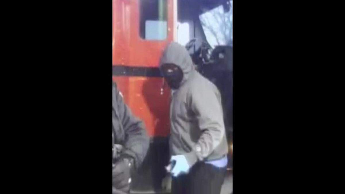 The FBI released this surveillance photo of a suspect during the armed robbery Thursday to Brink’s armored vehicle drivers in Madison.