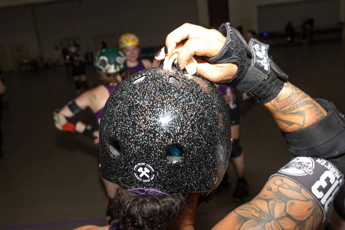 “D-Woww” rests her mouthguard on top of her helmet after the conclusion of a successful bout in Collinsville on May 31.