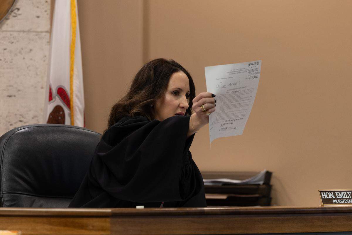 Madison County Associate Judge Emily Nielsen holds up a form waiving the right to a detention hearing for DJ W. Marshall, 26, who is accused of shooting and injuring Granite City Police Officer Tyler Timmons.