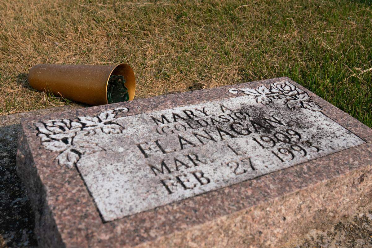 A tombstone of a union miner in Mt. Olive, Ill. Many organizers’ families leave remembrances of them by their graves, such as this bell that a miner would have used for signaling purposes.