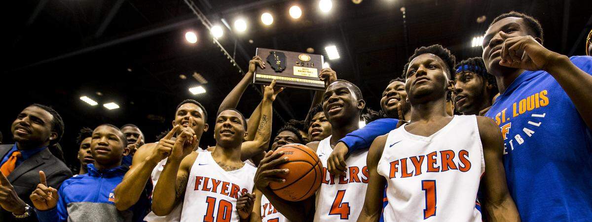 March 12, 2019 - Springfield, IL - East St.LouisÕ East St.LouisÕ Cornelius Leflore, East St.LouisÕ Traeveion Jones and Jashawn Anderson celebrate the flyerÕs victory over Springfield (Southeast) with teammates after winning the IHSA 3A Super-Sectional basketball game Tuesday night in Springfield. Photo: Chris Johns