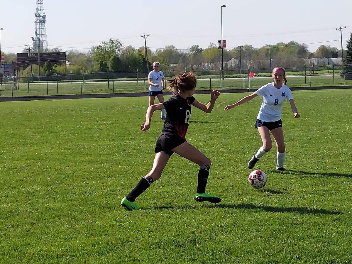 Highland’s Peyton Frey races in to take away a loose ball from Mater Dei’s Emma Cowgill during a non-conference game Wednesday, April 27, at Highland High School. The Lady Bulldogs ultimately lost 4-0.