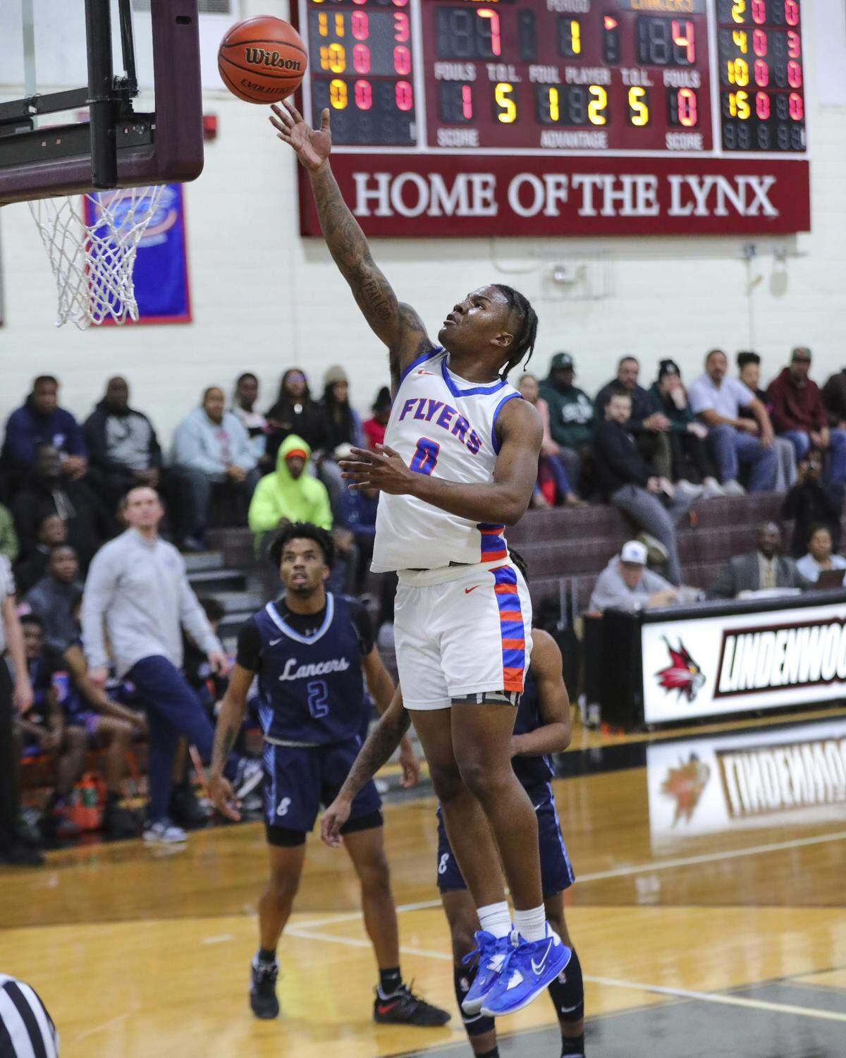 East St. Louis guard Macaleab Rich drives to the basket during Tuesday night’s Southwestern Conference game against Belleville East. The Flyers ultimately posted a 72-71 victory.