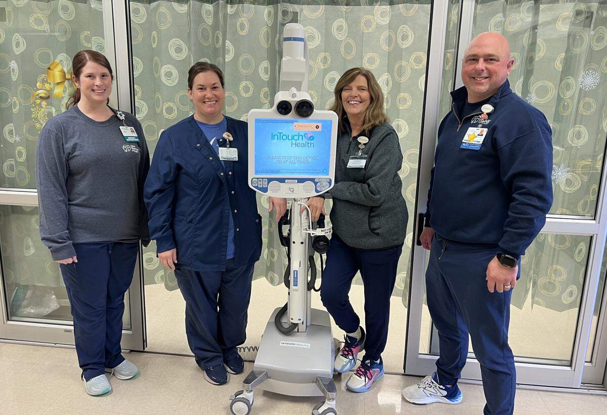 (Left to right) HSHS St. Joseph’s Hospital Highland emergency department RN’s Alyson and Colleen; Carol Lowery, team lead; and Patrick Small, emergency department manager, with the telemedicine cart and monitor used by St. Joseph’s Hospital to help rapidly diagnose stroke patients by connecting with a tele-neurologist for examination.
