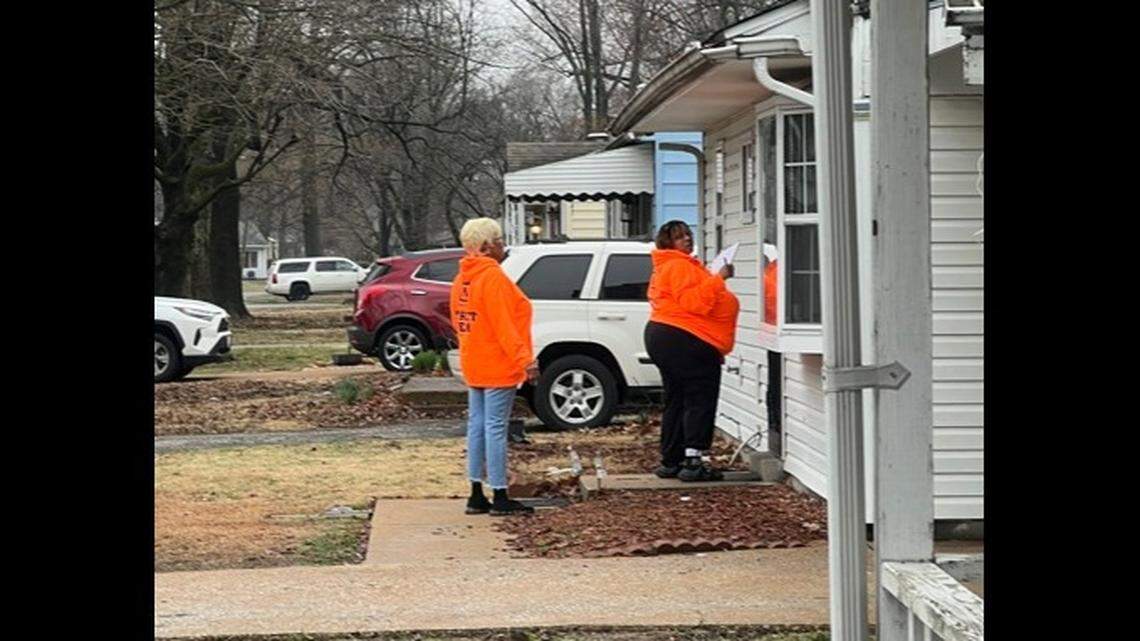 Volunteers with Metro East Organizing Coalition make contact with a Belleville resident during a Peace Walk earlier this year. Their goal is to help prevent violence in neighborhoods.