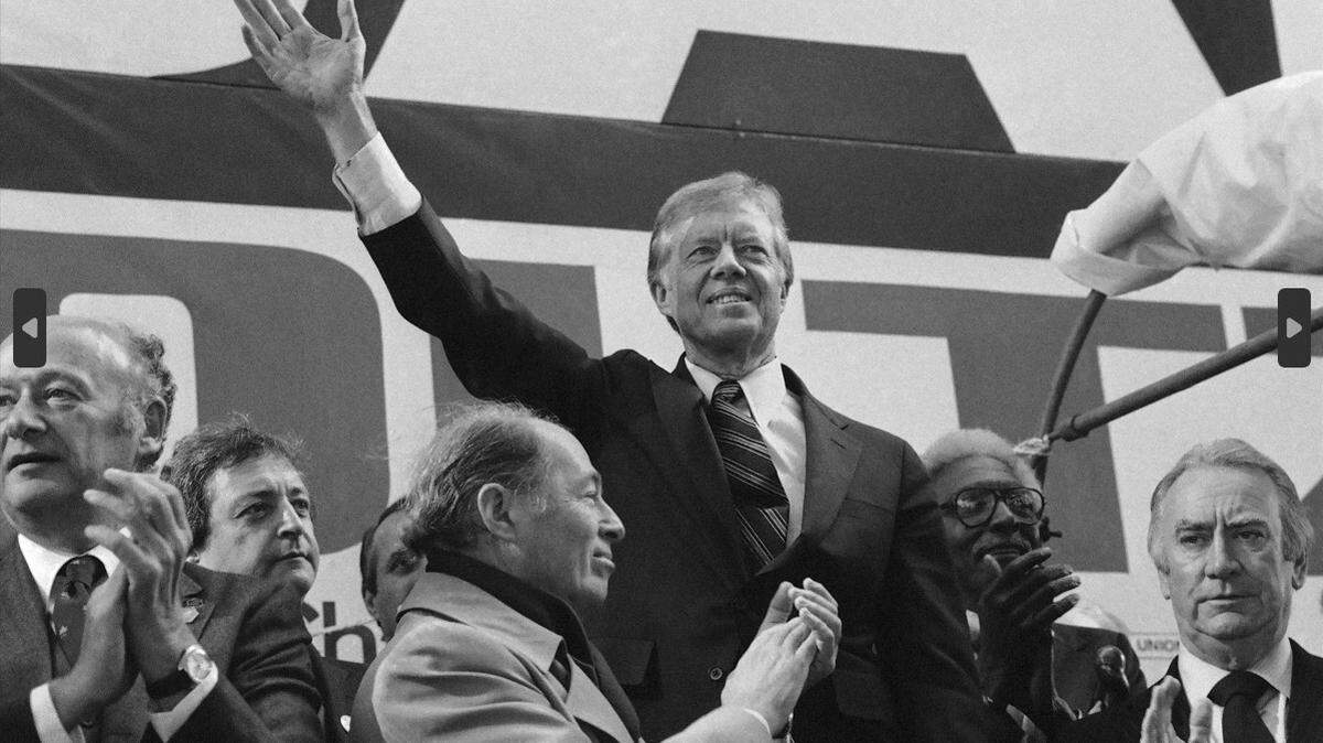 U.S. President Jimmy Carter waves to supporters on Oct. 30, 1980, in New York City as Mayor Ed Koch applauds, far left. Four days later, Carter was campaigning in southern Illinois.