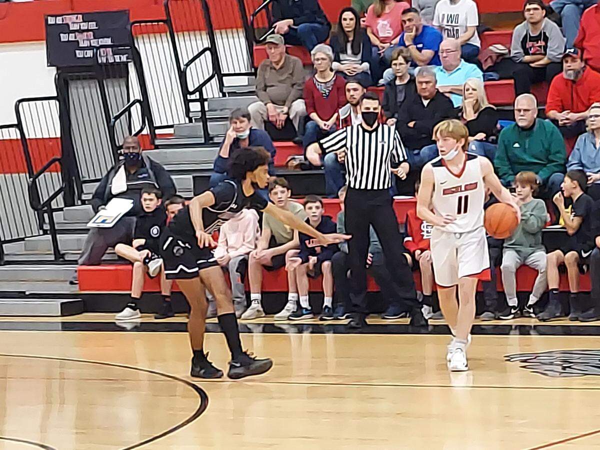 Highland sophomore guard Jake Ottensmeier looks to take Mascoutah’s Justin King off the dribble during the Mississippi Valley Conference opener for both teams Friday, Dec. 3, at Highland High School. The Indians ultimately defeated the Bulldogs 56-47.