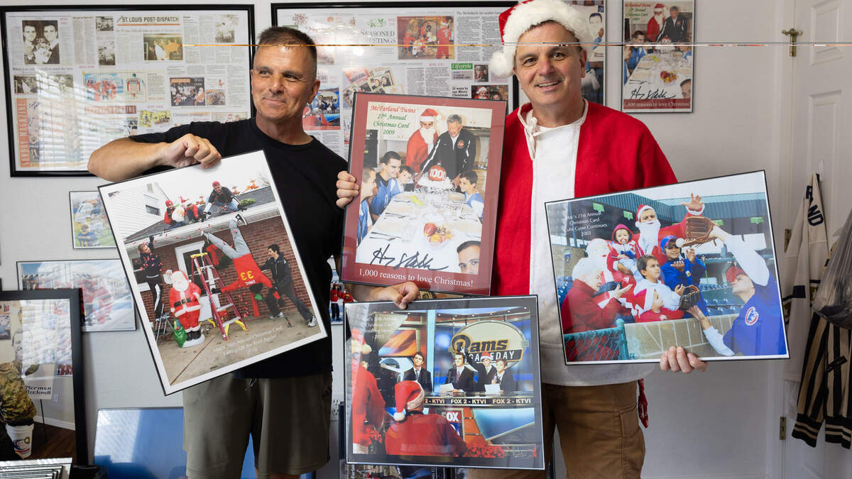 Kevin (left) and Dave McFarland are well known in the metro-east for their famous Christmas cards, which they have sent out for forty years and which will soon be hosted in a gallery at SWIC. In Kevin McFarland’s home, pictured here, one room is filled top-to-bottom with news clippings, framed cards and mementos from previous holiday photoshoots.