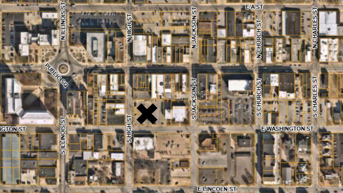 An X marks a parking lot at South High and East Washington streets, behind the former Ben’s store, where a developer would like the city of Belleville to build a parking garage.