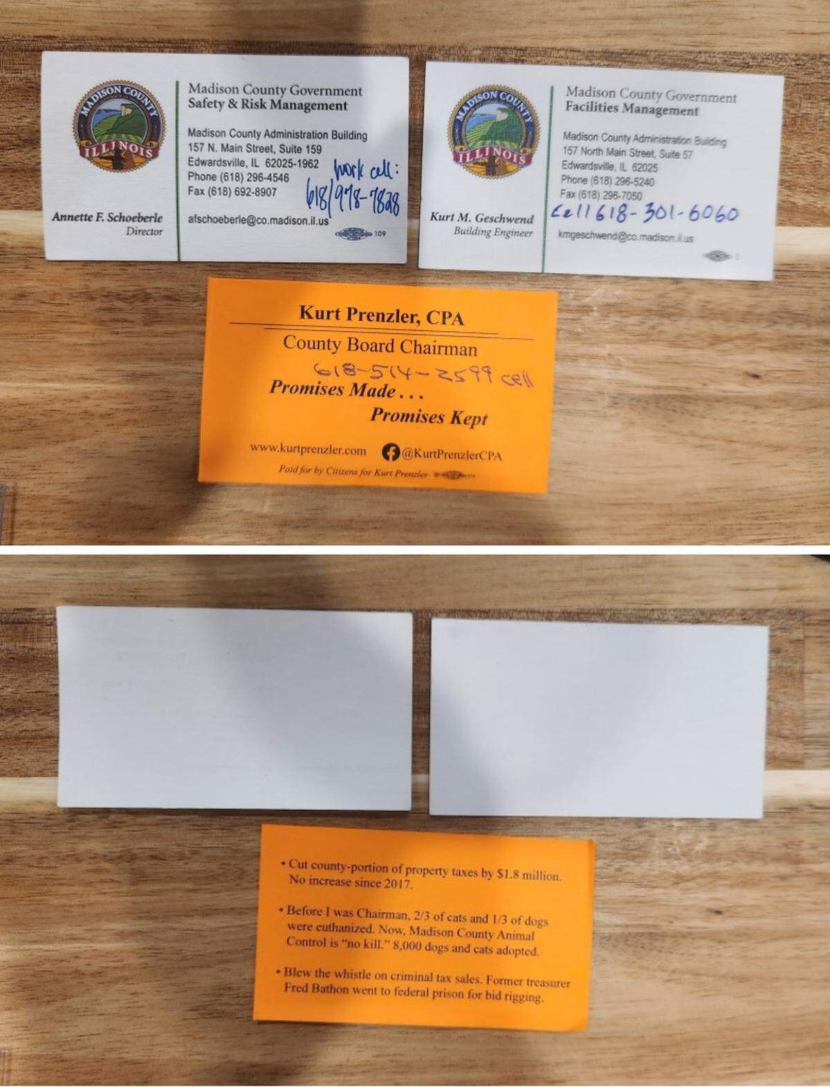Madison County Board Chairman Kurt Prenzler’s “campaign-type” business cards, as described by the county’s ethic’s adviser, are shown next to examples of official county business cards.