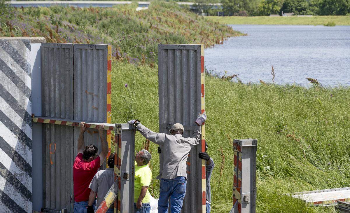 Metro East Sanitary District employees install a flood gate on Water St. in Cahokia Thursday. The gates help protect Cahokia, East Carondelet, and the North Dupo area. The Mississippi is predicted to crest on June 4th at 46 feet in St. Louis, at that level water will be at the base of the flood gate on Water St. in Cahokia.