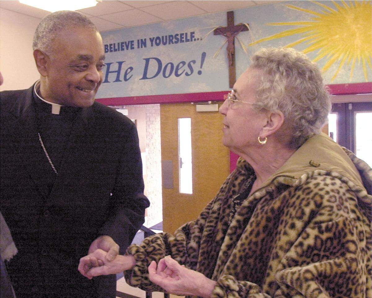 Bishop Wilton D. Gregory speaks with Gert Amann, a parishioner in the Catholic Diocese of Belleville, in this 2004 file photo.