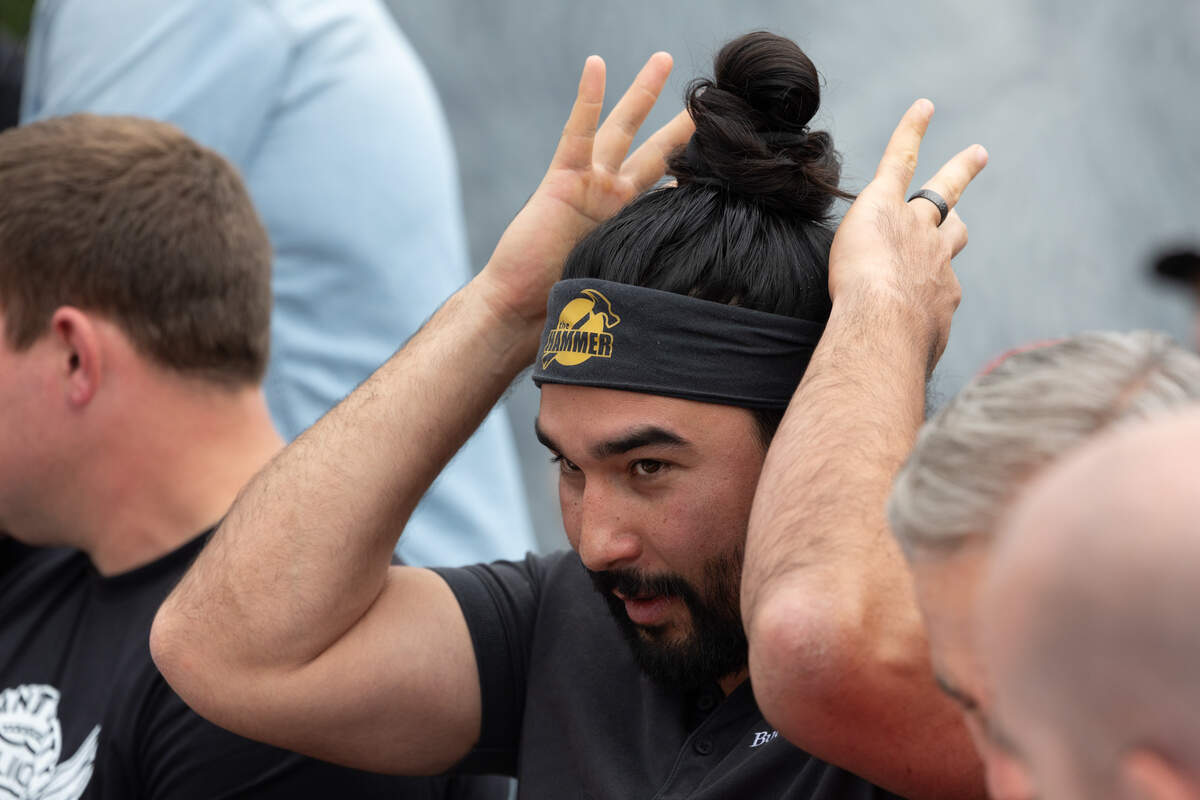 Kyle “The Hammer” Hanner ties on his signature “Hammer” headband prior to starting the Big Texan steak challenge.