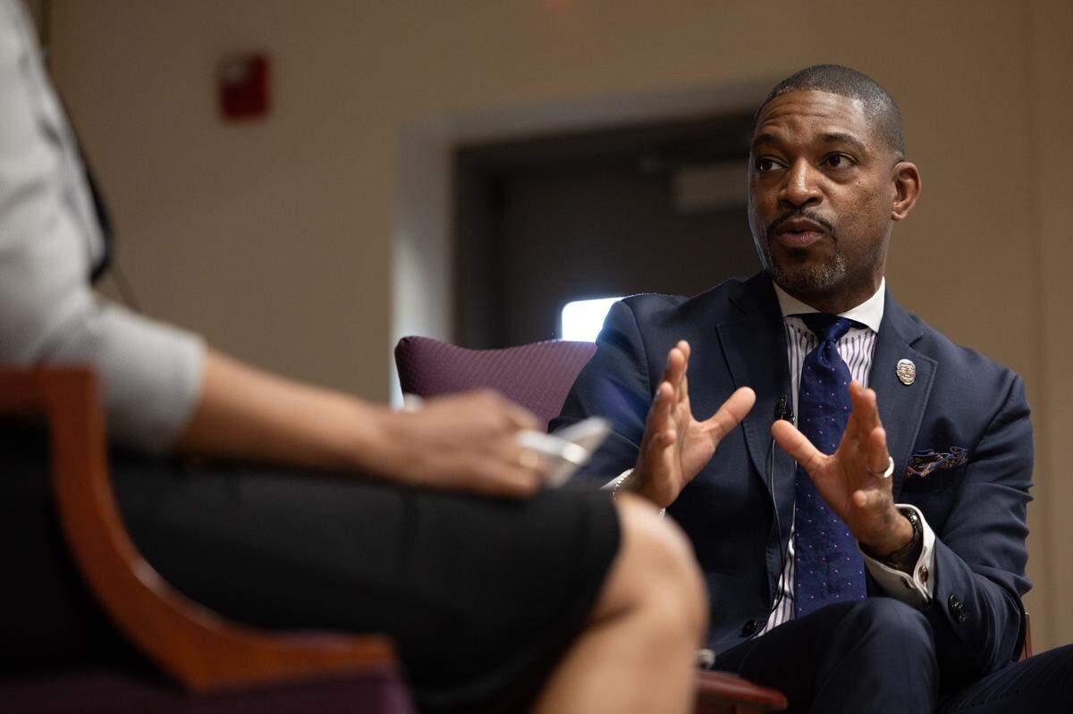 Rev. Starsky Wilson, president and CEO of the Children’s Defense Fund, talks about the root causes of systemic poverty with Tasha Green Cruzat, president of Children’s Advocates for Change, during a forum on child poverty in East St. Louis, Ill., on Sept. 10, 2024.