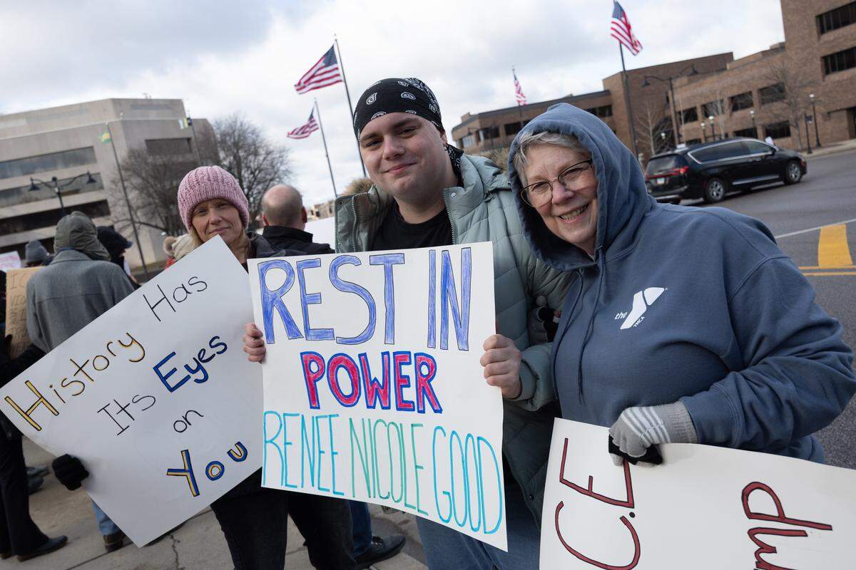 Three generations of protesters stand together during a demonstration at Belleville’s Public Square on Saturday, Jan. 10.
