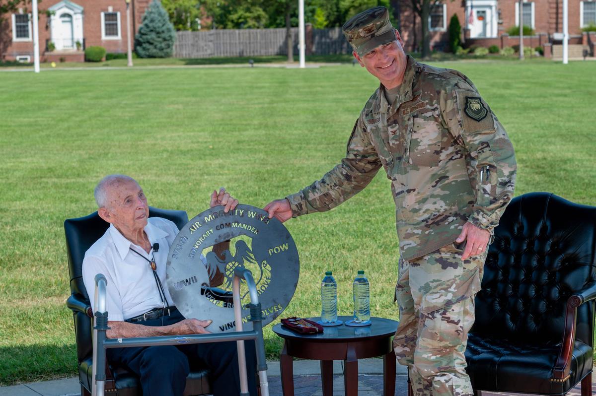 Wilbert “Vince” Rolves accepts a token of appreciation from Col. Chris Robinson, 375th Air Mobility Wing commander, during a POW/MIA closing ceremony on Scott Air Force Base. The ceremony included a speech from Rolves, who was a prisoner of war for 18 months in Germany during World War II and is a recipient of a Silver Star, Bronze Star and two Purple Hearts.