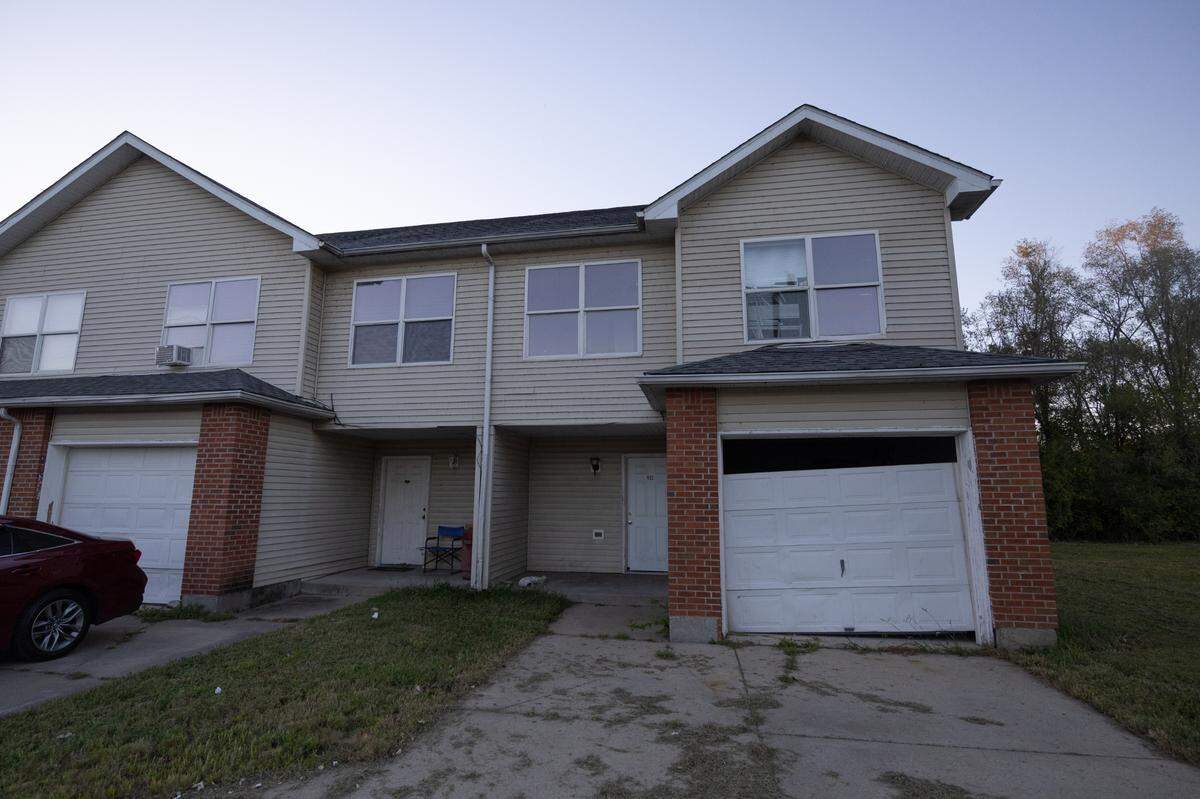 A Centreville Courts apartment has a damaged front door, broken blinds and a garage door that has come off its hinges.