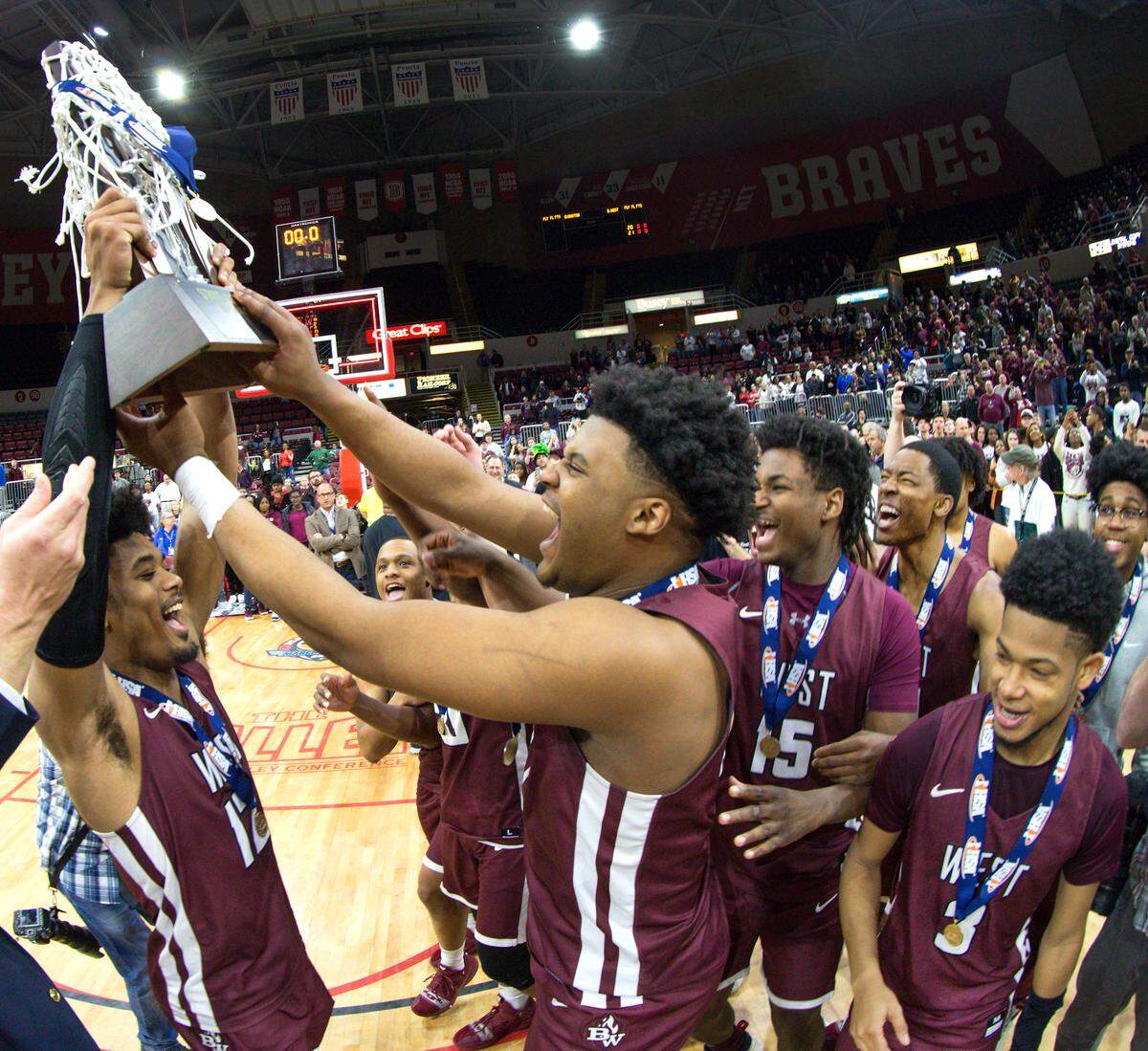 Belleville West William Shumpert left and Belleville West Keith Randolph celebrate their 71-59 victory over Evanstion during Saturday’s Class 4A State State Championship game at Peoria Carver Arena.