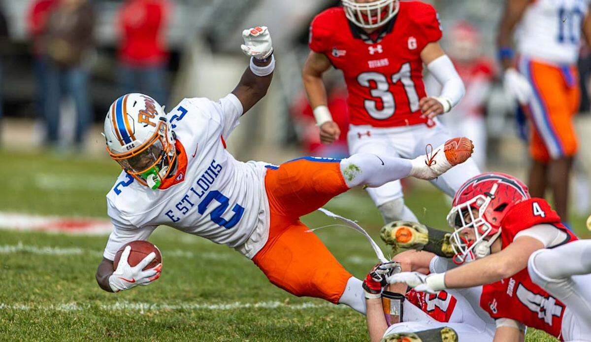 East St. Louis’ Ronnie Gomiller is tackled by Glenwood defense during Saturday’s IHSA Class 6A second round football game.