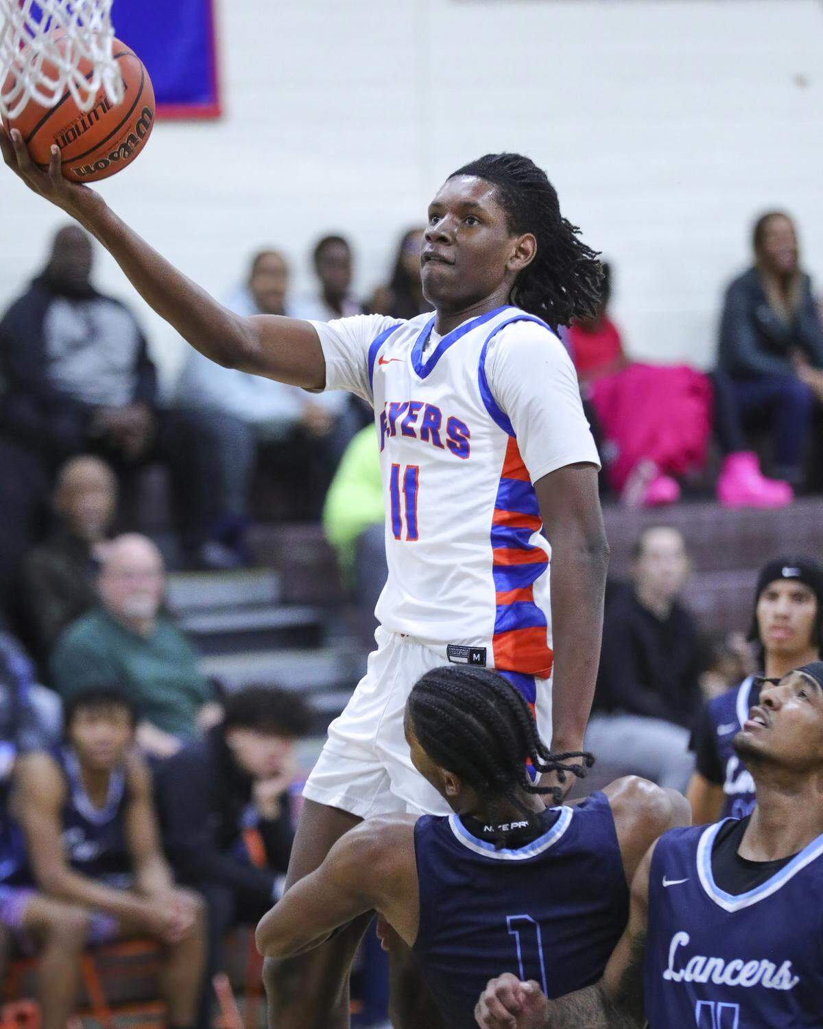 East St. Louis forward Davis Bynum drives to the basket during Tuesday night’s Southwestern Conference game against Belleville East. The Flyers ultimately posted a 72-71 victory.