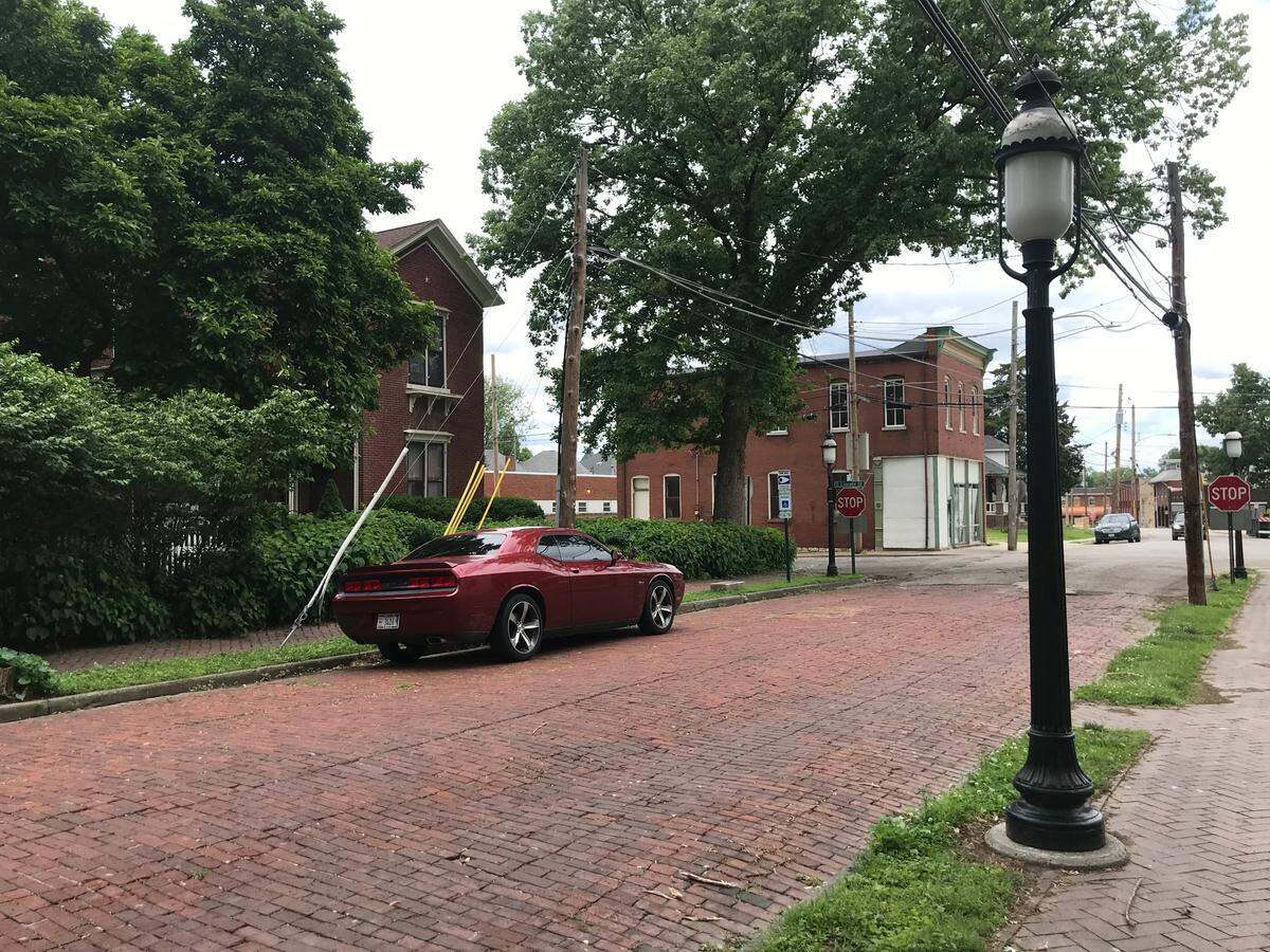 This photo shows the proximity of tree-lined Abend Street in Old Belleville Historic District to the 1887 brick building on Mascoutah Avenue that may be renovated. It’s on the corner in the distance with white plywood and paper over windows.