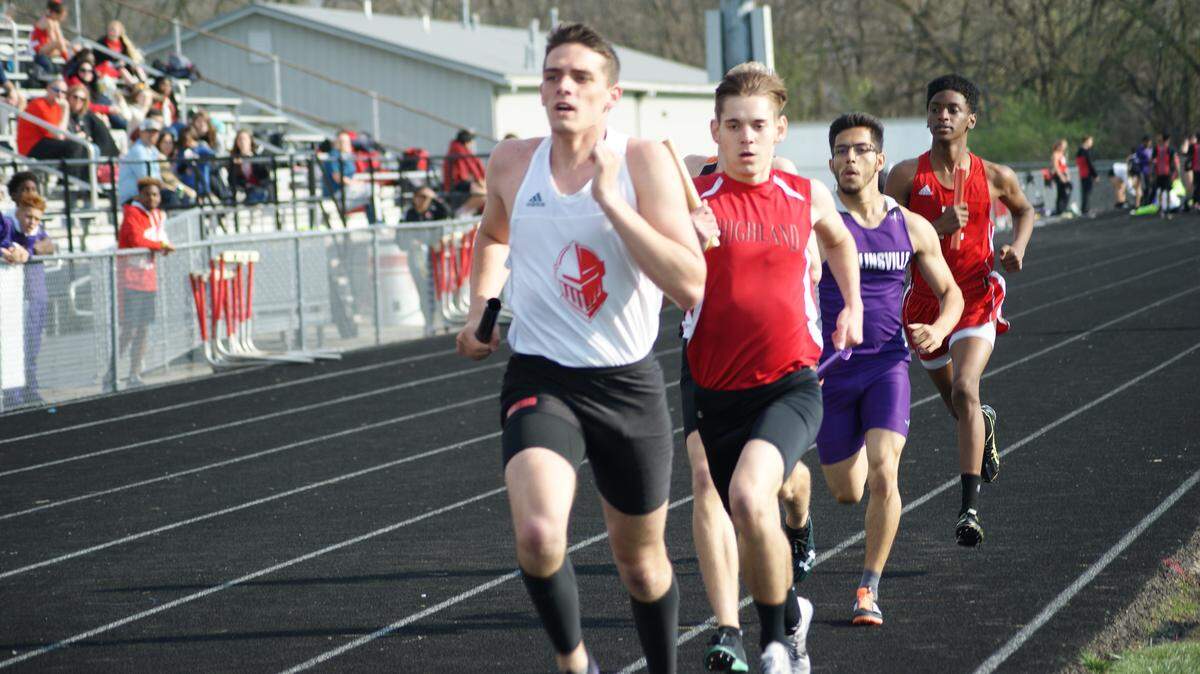 Highland sophomore Nick Hanratty follows Triad's Zach Knopf during the opening leg of the 4 x 800-meter relay in which the Bulldogs finished third behind Edwardsville and the Knights at the Madison County Championships Tuesday, April 24 at Highland High School.