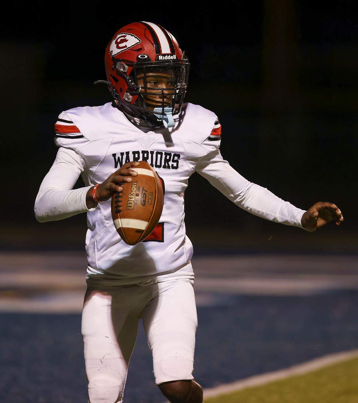 Granite City quarterback Ian Poston looks downfield for an open receiver Friday’s non-conference game against Belleville East. The Warriors ultimately lost to the Lancers.