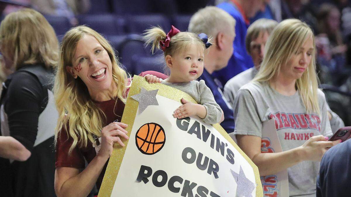 Gibault Catholic’s Gavin Kesler fans Katrina and Ruby Wright prepare for Saturday’s IHSA Class 1A state championship game against Scales Mounds at the State Farm Center on the campus of the University of Illinois. Gibault ultimately prevailed 65-45 to claim the state title. A parade/celebration to honor the team is set for Sunday.