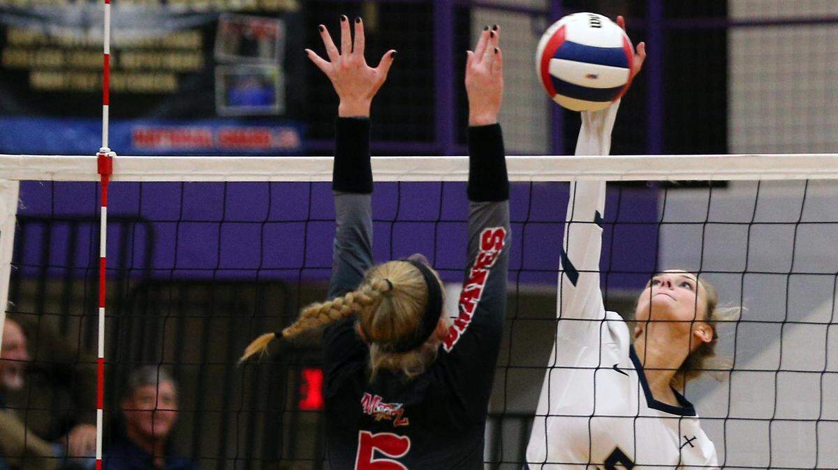 Althoff’s Grace Strieker works at the net during the Civic Memorial Super Sectional game between Mt. Zion and Althoff Friday night in Bethalto.