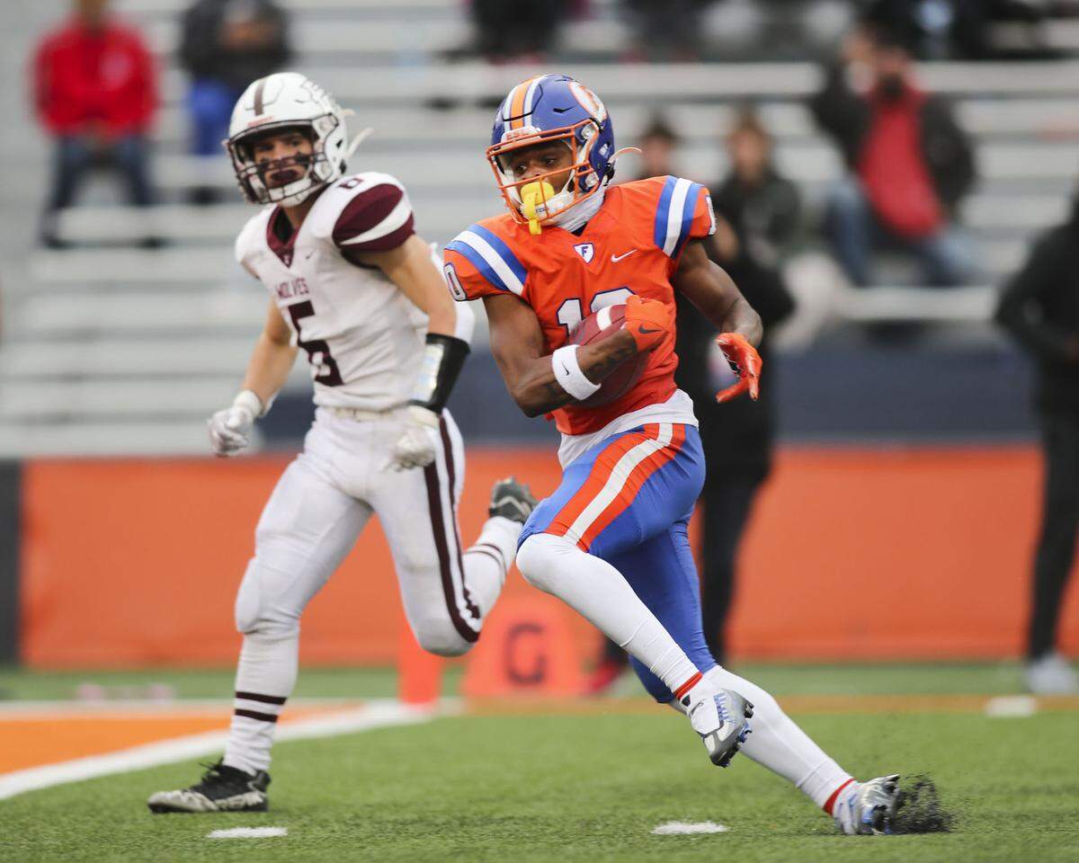 East St. Louis wide receiver Jesse Watson heads into the end zone during the IHSA Class 6A state championship game against Prairie Ridge at Memorial Stadium on the campus of the University of Illinois in Champaign. Watson and the Flyers rolled to a 57-7 victory, securing the program’s 10th state championship.