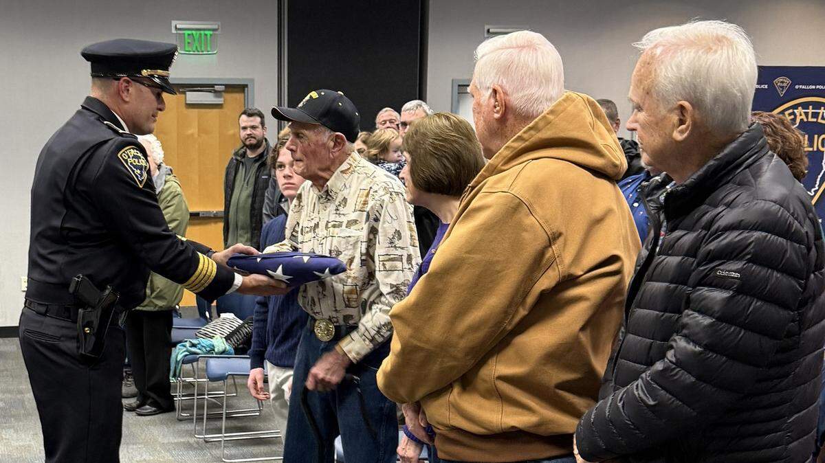 The Police Color Guard presents the flag to Gerald Schmitt, Benjamin Schmitt’s oldest surviving grandson.