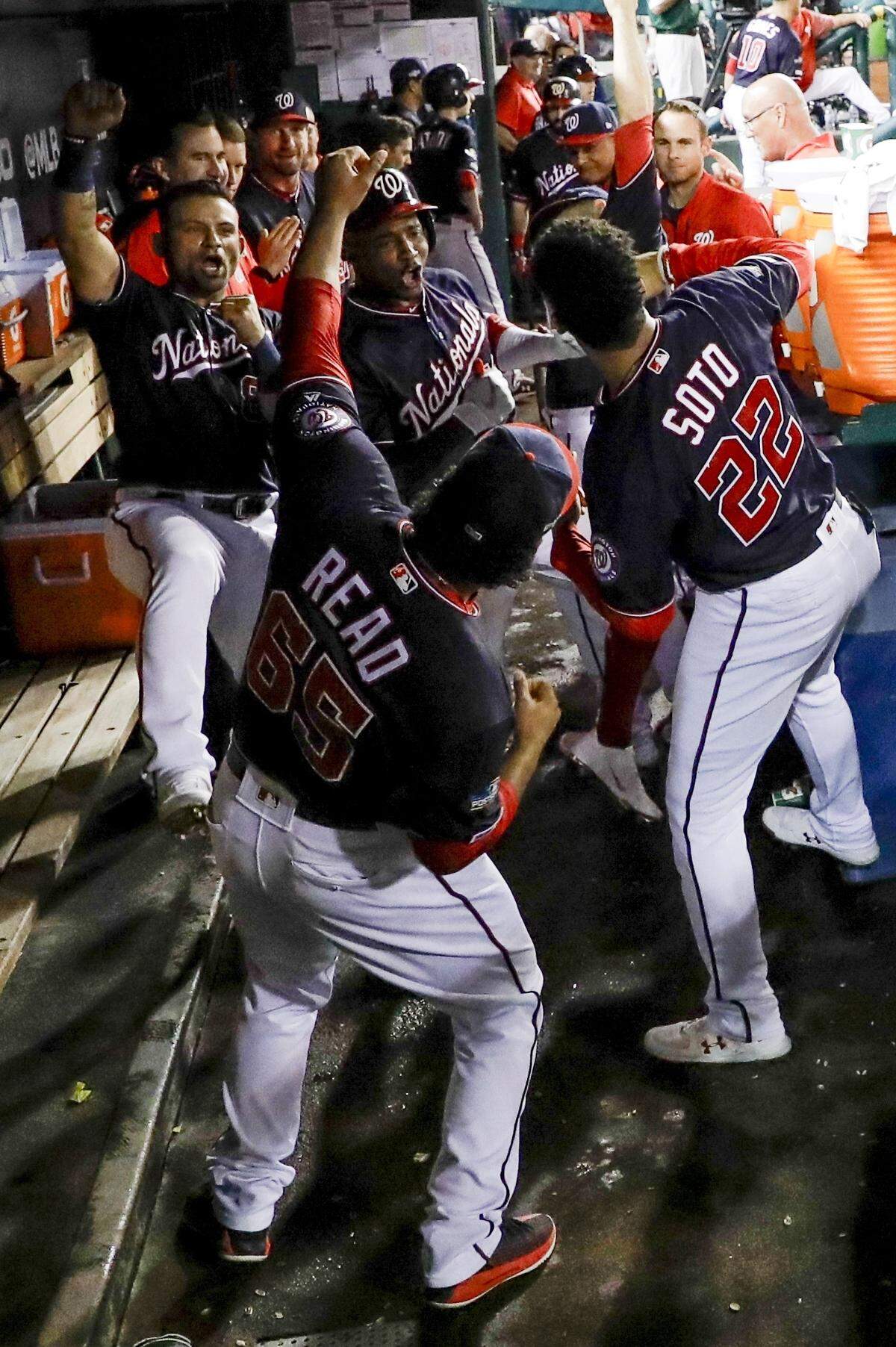 Washington Nationals’ Victor Robles celebrates with teammates after hitting a home run during the sixth inning of Game 3 of the baseball National League Championship Series against the Washington Nationals Monday, Oct. 14, 2019, in Washington. (AP Photo/Jeff Roberson)