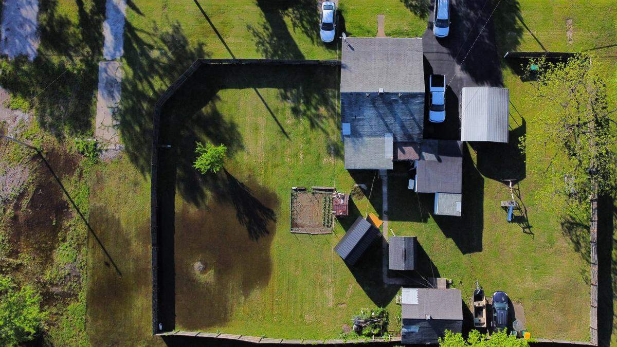 Sewage-contaminated water floods a Cahokia Heights resident’s property on in spring 2024, after rain caused a sewage pump station to overflow over three days prior.