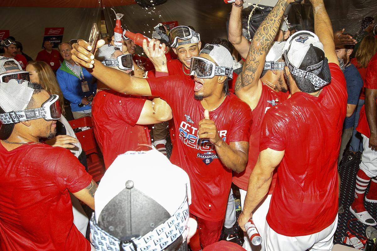 St. Louis Cardinals players celebrate their victory after a baseball game Sunday, Sept. 29, 2019, in St. Louis. The Cardinals clinched the NL Central on the final day of the regular season, to win their first division title since 2015 with a 9-0 victory over the Chicago Cubs. (AP Photo/Scott Kane)