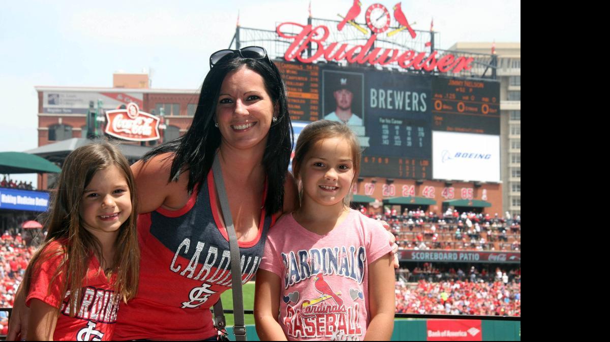 
“We definitely like the atmosphere, and how much the fans like the Cardinals. (My daughters) both play softball. (Mikayla) catches and loves Yadi. (Kennah) wants to pitch. They play for the Khoury League in Belleville.” Their favorite stadium treats? “I love the nachos. The girls like the ice cream in helmets.” — Stacy Barringer, 30, of Belleville, with daughters Mikayla, 9, and Kennah, 7. Stacy sells Scentsy products.
