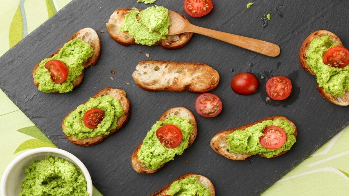 Bright green frozen peas are the base of this winter pesto on garlic crostini.