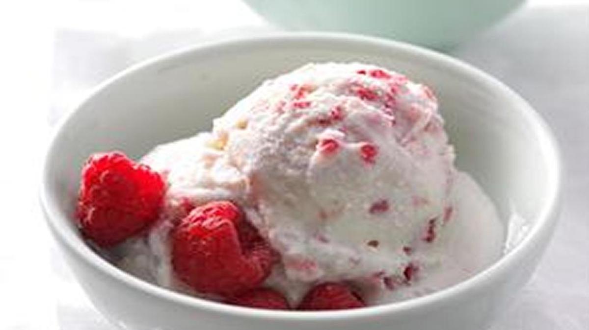 Raspberry Ice Cream is made by putting ingredients in plastic freezer bags and shaking the mixture until set, about 5 minutes. Kids can even toss it around outside.