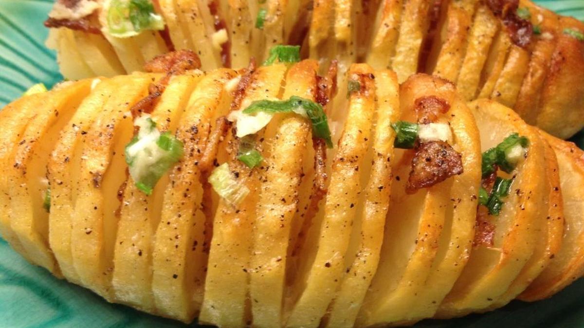 Add green onions and bacon pieces to your Hasselback Potatoes.