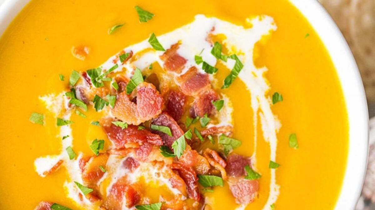 Creamy sweet potato soup with apple, bacon.
