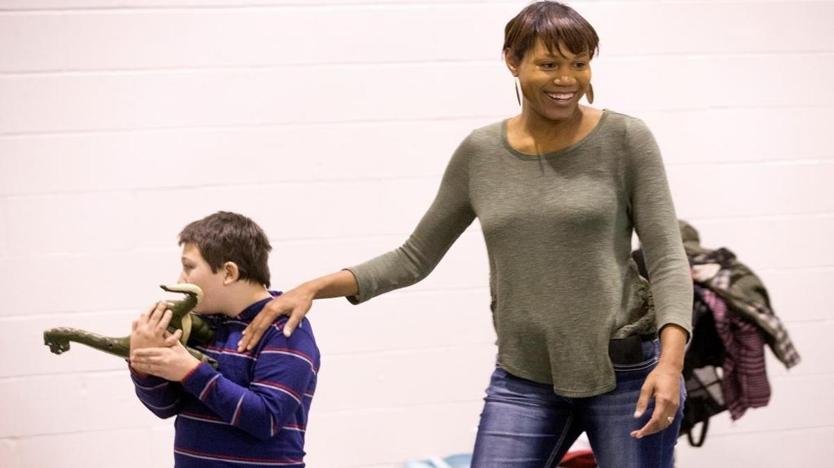 Melanie Stith, founder of Elisha’s Cove, smiles at another group member as she walks with Jacob Bechtoldt. The new nonprofit provides respite services to families of children who have special needs. Parents get a break one Saturday of each month when the children get together to enjoy basketball, arts and crafts, games and movies. All staff who work with the children are volunteers.